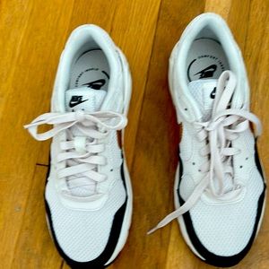 New Nike Air sneakers. Worn once. White with black and gold logo. Original box.